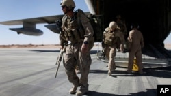FILE - U.S. Marines are seen disembarking from a C-130 transport plane.
