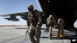 FILE - U.S. Marines are seen disembarking from a C-130 transport plane.