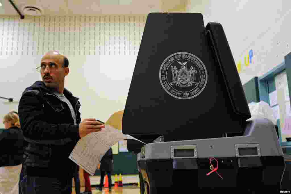 Najeeb Kaid, a U.S. citizen from Yemen, prepares to cast his ballot at a polling station in the Bay Ridge neighborhood of Brooklyn, New York.