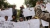 FILE - A Sept. 2014 photo shows protesters holding posters during a rally against the Islamic State group, in Jakarta, Indonesia.