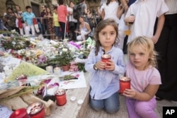 Children light candles honoring investigative reporter Daphne Caruana Galizia, in Valletta, Malta, Oct. 22, 2017.