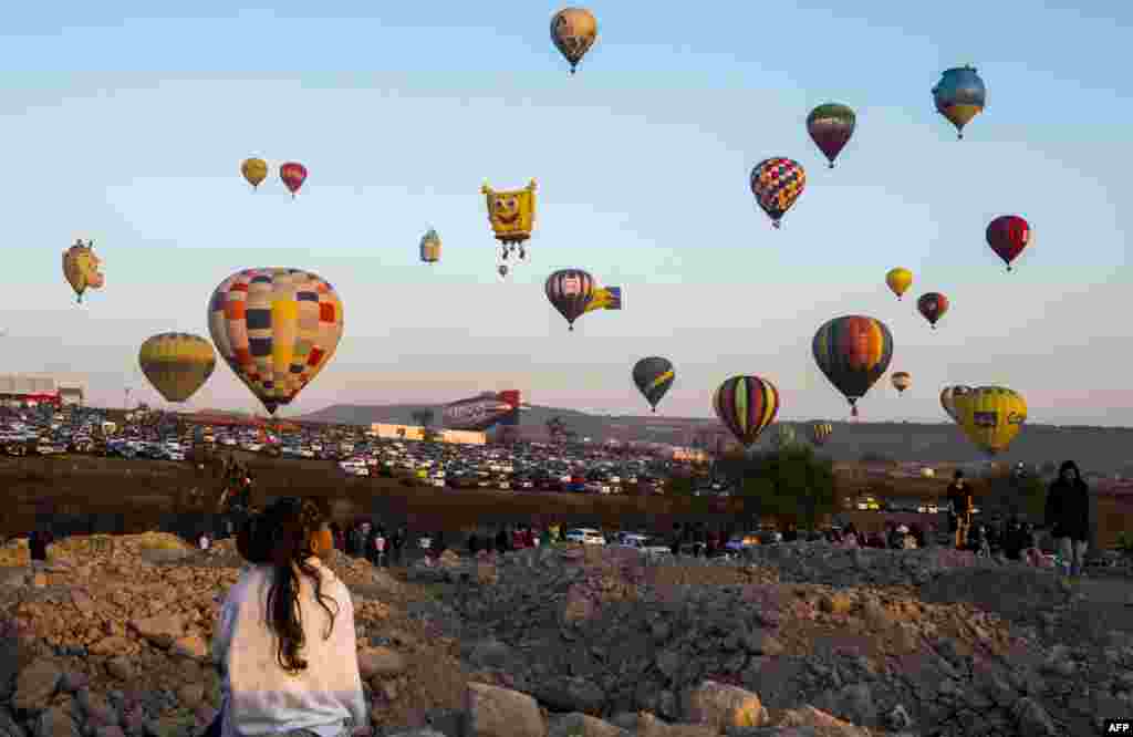 A girl enjoys the hot-air balloons festival in Cajititlan, Jalisco state, Mexico.
