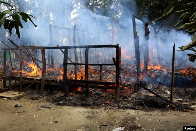 FILE - A house is seen on fire in Gawduthar village, Maungdaw township, in the north of Rakhine state, Myanmar, Sept. 7, 2017.