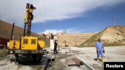 FILE - Employees work at strengthening the Mosul Dam in northern Iraq, April 18, 2016. 