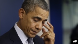 President Barack Obama wipes his eye as he speaks about the elementary school shooting in Newtown, Connecticut, Friday, Dec. 14, 2012, in the briefing room of the White House.