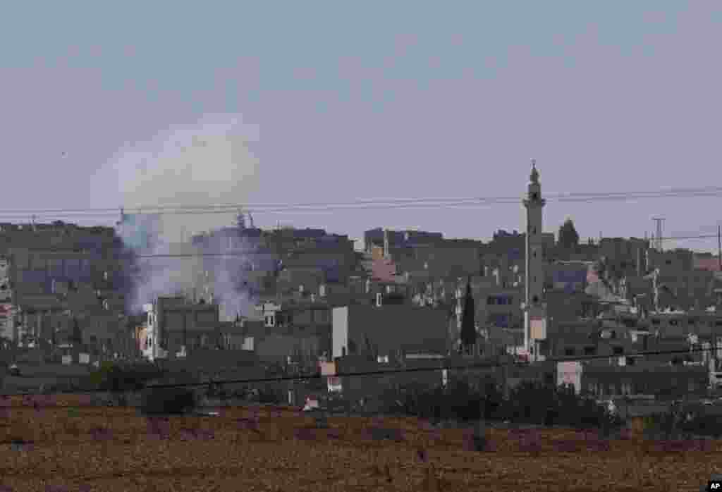 Smoke rises after an explosion inside Kobani, Syria, Oct. 7, 2014.