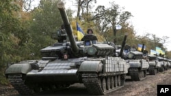 Ukrainian tanks move near Mariupol, Donetsk region, eastern Ukraine, Oct. 21, 2015.