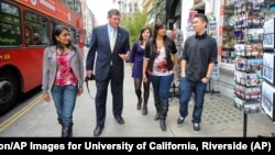 In this 2012 photo, Timothy P. White, Chancellor of the University of California, Riverside, second from left, visits UCR students who are studying abroad in London.