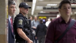 A police officer for Amtrak, the national passenger railroad, stands guard at Pennsylvania Station in New York on Friday