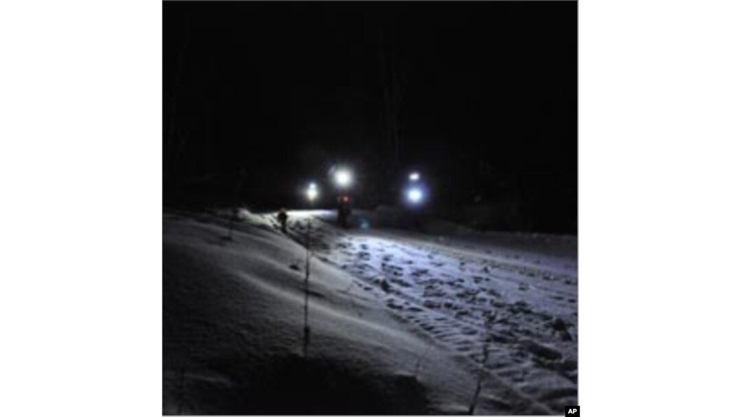 Cyclist leaders at mile marker 109 (175 km) at night.