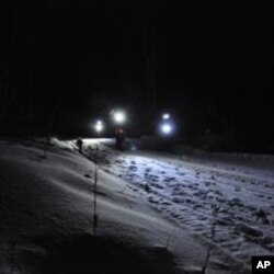 Cyclist leaders at mile marker 109 (175 km) at night.