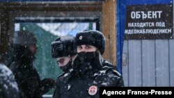 Russian police officers patrol near Listvyazhnaya coal mine in the Kemerovo region near the town of Belovo after an accident Nov. 25, 2021.