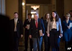 Senate Majority Leader Mitch McConnell, R-Kentucky, walks to the chamber on the first morning of a government shutdown after a divided Senate rejected a funding measure last night, at the Capitol in Washington, Jan. 20, 2018.