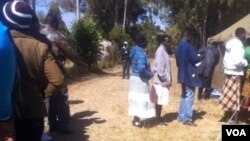 Voters captured recently waiting to cast their ballots in the Zimbabwe general election won by President Robert Mugabe's Zanu PF