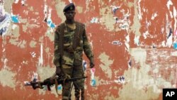A soldier stands guard in a street near the National Assembly on April 13, 2012 in Bissau.