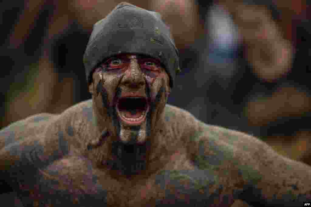 A competitor shouts as he takes part in the &#39;Tough Guy&#39; adventure race near Wolverhampton, central England.