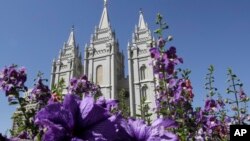 FILE - Flowers bloom in front of the Salt Lake Temple. in Temple Square, in Salt Lake City, Sept. 3, 2014.