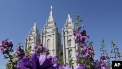 FILE - Flowers bloom in front of the Salt Lake Temple. in Temple Square, in Salt Lake City, Sept. 3, 2014.