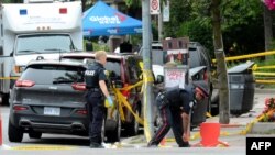 Toronto Police investigate the scene of a shooting from the night before in Toronto, Ontario, Canada on July 23, 2018. 