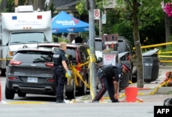 Toronto Police investigate the scene of a shooting from the night before in Toronto, Ontario, Canada on July 23, 2018.