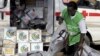 A local health worker carries vaccination kits into a vehicle at a distribution center ahead of the start of a nationwide polio immunization campaign in Lagos, Nigeria, February 21, 2011.