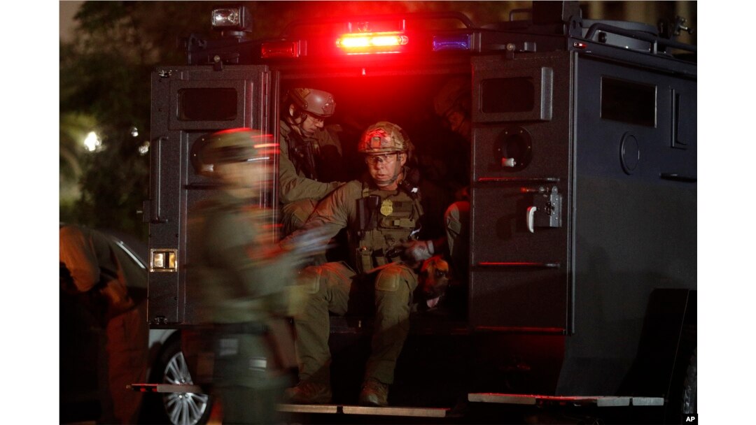 FILE - U.S. law enforcement agents board a truck to conduct an early morning raid against members and associates of the MS-13 gang, May 17, 2017, in Los Angeles, California. MS-13 has morphed into one of the largest and most violent gangs in the United States, boasting an estimated 10,000 members.