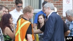 Canadian Prime Minister Stephen Harper greets families following a press conference at Lac-Mégantic high school on July 7, 2013 in Lac-Megantic, Quebec, Canada, one day after a train derailment and subsequent explosion and fire.