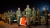 Military pallbearers stand to attention next to the coffins of four Kenyan soldiers who were killed in Somalia, at a ceremony to receive their bodies which were airlifted to Wilson Airport in Nairobi, Kenya, Jan. 18, 2016.