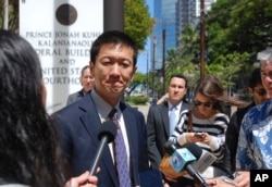 FILE - Hawaii Attorney General Douglas Chin speaks outside federal court in Honolulu, March 29, 2017.