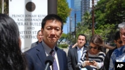 FILE - Hawaii Attorney General Douglas Chin speaks outside federal court in Honolulu, March 29, 2017. 