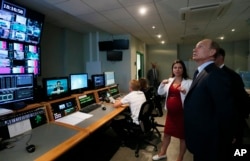 FILE - Russian President Vladimir Putin visits the headquarters of what was then known as the Russia Today television channel in Moscow, June 11, 2013. Major brands in the export division of Russian media include RT, the RIA Novosti news agency, Sputnik, and the Voice of Russia radio station.