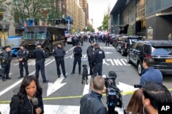 New York Police stand outside the Time Warner Center at Columbus Circle, Wednesday, Oct. 24, 2018 in New York. A police bomb squad was sent to CNN's offices at the center, and the newsroom was evacuated because of a suspicious package.