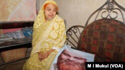 With the photo of Habibur Rahman, his mother sits in her Chittagong home a day after he was killed May 18 in the ongoing anti-drug campaign in Bangladesh. Family members of Rahman insist that he was a religious man and had had no connection with narcotics.