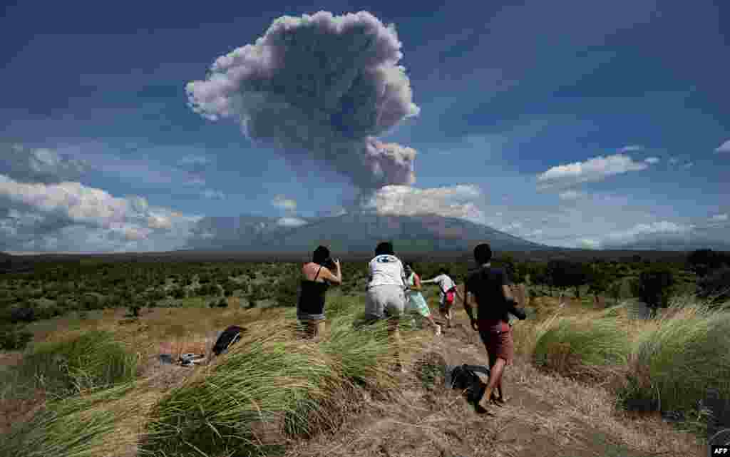 A plume of ash is released as Mount Agung volcano erupts, seen from the Kubu subdistrict in Karangasem Regency on Indonesia&#39;s resort island of Bali.