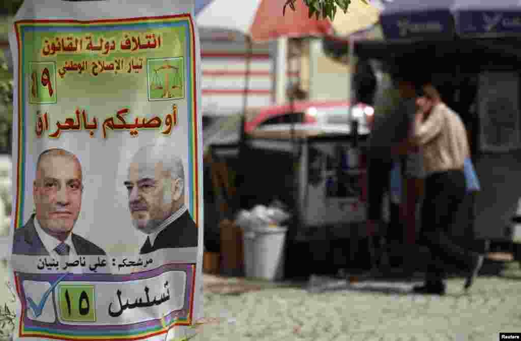 An Iraqi walks past a provincial elections campaign poster in Baghdad, April 18, 2013. Iraq will hold its provincial elections on Saturday. The poster reads, &quot;take care of Iraq.&quot;
