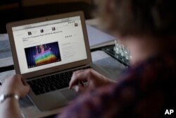 Transgender U.S. army captain Jennifer Sims checks the web on her laptop after an interview with The Associated Press in Beratzhausen near Regensburg, Germany, July 29, 2017.