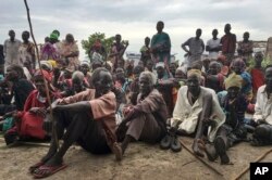 Displaced South Sudanese gather during a visit by the United Nations to a new site for displaced people in Bentiu, South Sudan, June 18, 2017.