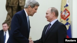 Russian President Vladimir Putin (R) welcomes U.S. Secretary of State John Kerry during a meeting at the Kremlin in Moscow, Russia Dec. 15, 2015. 