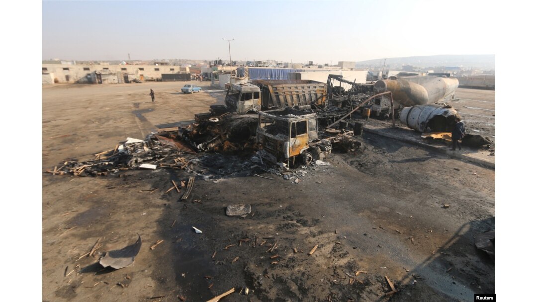 FILE - A general view shows damaged trucks after what activists said were airstrikes carried out by the Russian air force, on a parking garage for cargo trucks in al-Dana town, near the Syrian-Turkish border in Idlib Governorate, Nov. 28, 2015.
