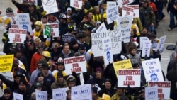 Firefighters show support for fellow union workers as they march at the Wisconsin state Capitol building on Monday