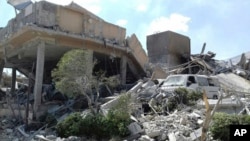 FILE - In this photo released by the Syrian official news agency SANA, shows the damage of the Syrian Scientific Research Center which was attacked by U.S., British and French military strikes to punish President Bashar Assad for suspected chemical attack