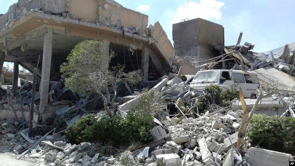 This photo released by the Syrian official news agency SANA, shows the damage of the Syrian Scientific Research Center on Saturday, April 14, 2018. Russia's military said Syrian air defense units downed 71 out of 103 cruise missiles launched by the U.S. and its allies. (SANA via AP)