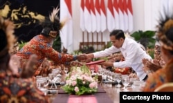 Presiden Jokowi menerima dokumen dari ketua delegasi papua, Abisai Rollo, di Istana Merdeka, Jakarta, 10 September 2019. (Foto: Setpres RI)