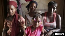 Refugees from the Malian town of Timbuktu, which is now under the control of Islamist forces, pose for a picture at their private accommodation in the West African country's capital Bamako September 8, 2012.