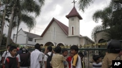 Indonesian youths gather outside the church that was attacked by Muslim hardliners in Temanggung, Central Java, Indonesia, February 8, 2011