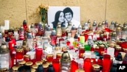 FILE - Candles are left in tribute to murdered Slovakian investigative reporter Jan Kuciak, 27, and his fiancee Martina, 27, at Slovak National Uprising Square in Bratislava, Feb. 27, 2018. 