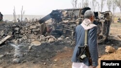 A man walks at the site of a Saudi-led air strike on an outskirt of the northwestern city of Sa'ada, Yemen, Aug. 4, 2017. 