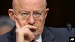 Director of National Intelligence James Clapper listens as he testifies on Capitol Hill in Washington, Mar. 12, 2013, before the Senate Intelligence Committee hearing on worldwide threats.