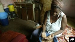 FILE: Faustine Janjira prepares food at her home in Highfields, a high density surburb in Harare, Tuesday, Oct, 17, 2006. (AP Photo/Tsvangirayi Mukwazhi)