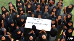 FILE - Muslim schoolgirls pose as they pray for world peace on the occasion of World Population Day at Jodhpur, India, July 11, 2014. 